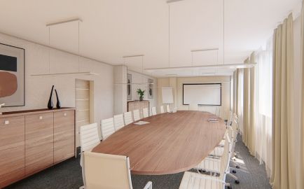 Místnost s dlouhým stolem a bílými židlemi